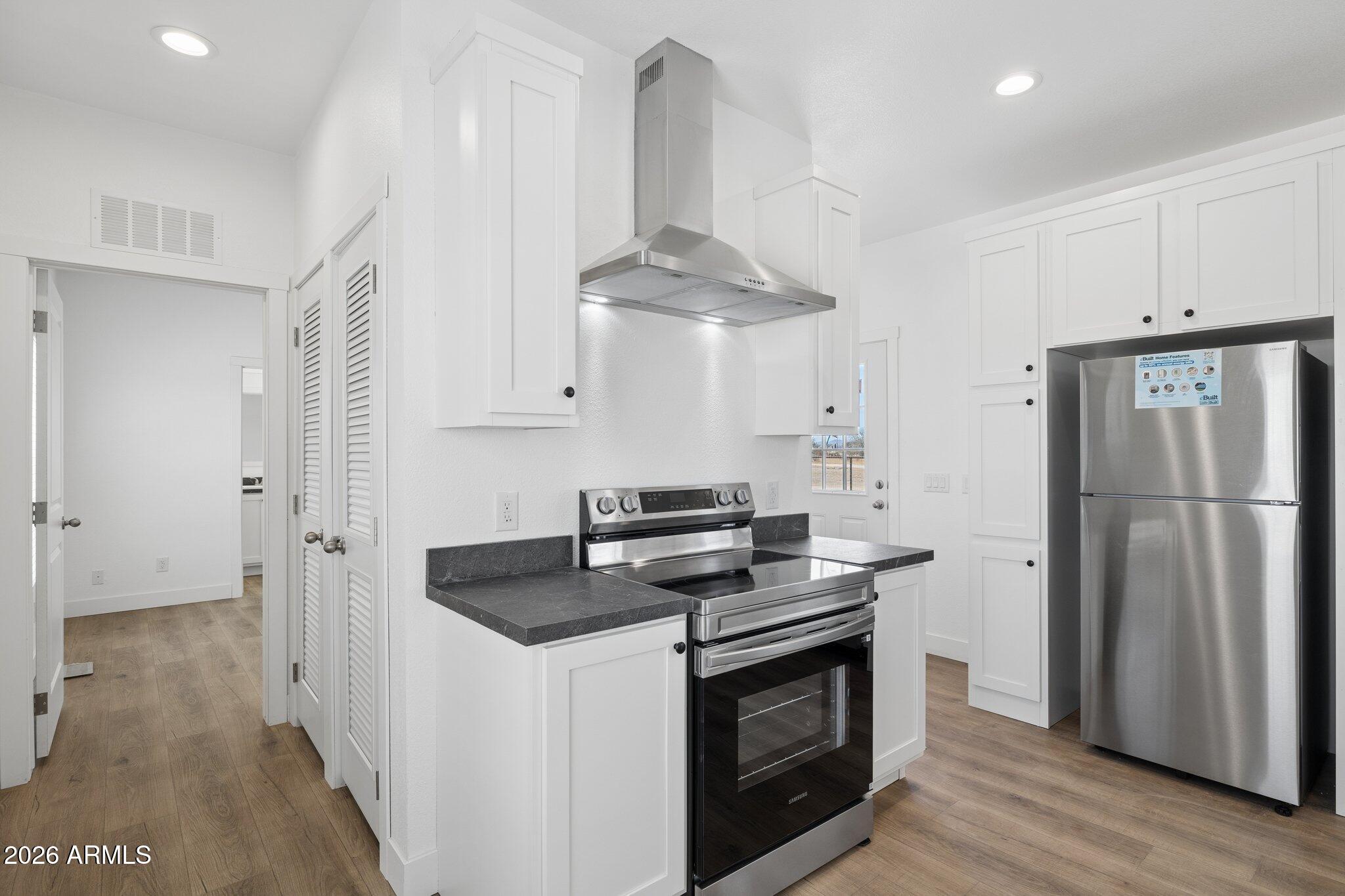 50044 West Century Road Maricopa, AZ 85139 - Photo 14 of 38 a kitchen with stainless steel appliances granite countertop a stove a refrigerator and a granite counter tops