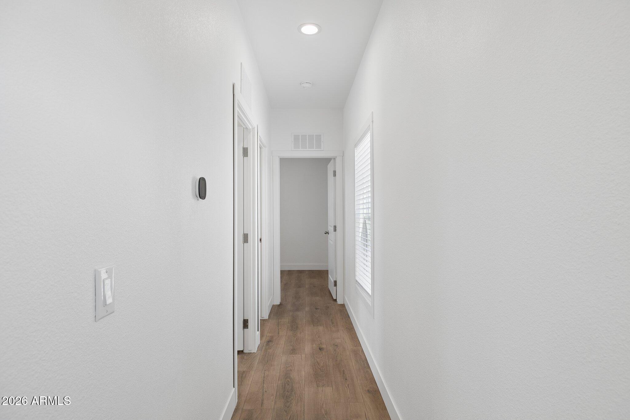 50044 West Century Road Maricopa, AZ 85139 - Photo 23 of 38 a view of a hallway with wooden floor