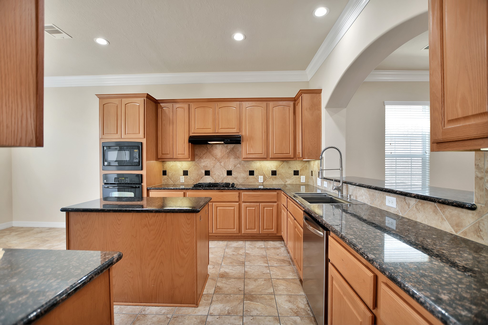 14459 Basalt Lane Houston, TX 77077 - Photo 13 of 35 Kitchen. Dark Granite countertops, center island, light brown cabinets with lots of space.