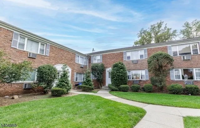 a view of a brick building next to a yard