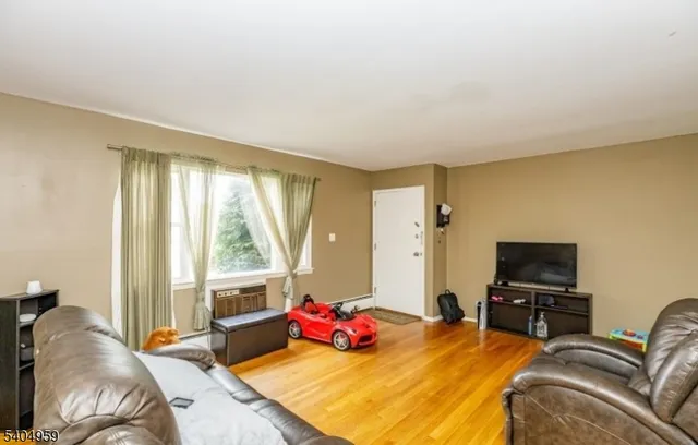 a bedroom with bed and a flat screen tv