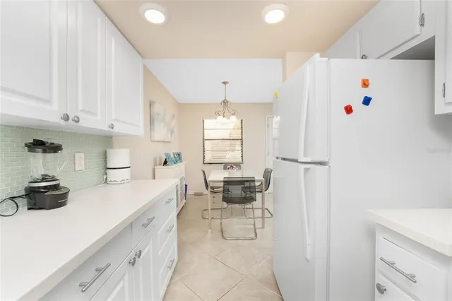 a kitchen with stainless steel appliances white cabinets and a refrigerator