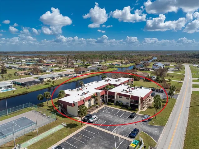 a view of a balcony with dining table and chairs