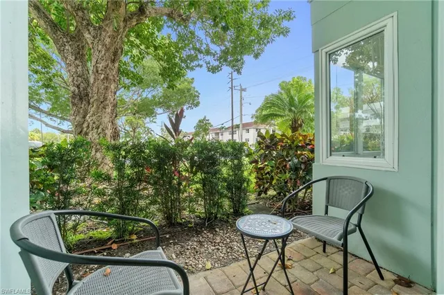 a view of a chair and table in backyard