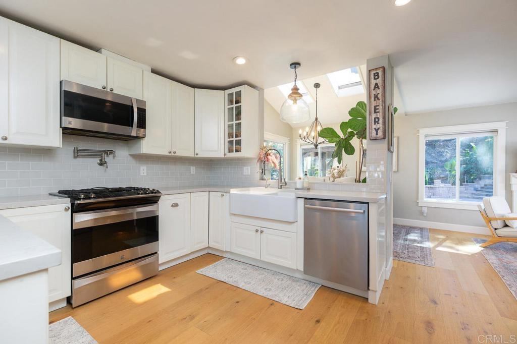 11061 Crystal Springs Road Santee, CA 92071 - Photo 13 of 30 a kitchen with a sink stove and microwave