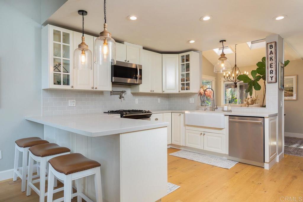 11061 Crystal Springs Road Santee, CA 92071 - Photo 14 of 30 a kitchen with stainless steel appliances kitchen island granite countertop a stove and a sink