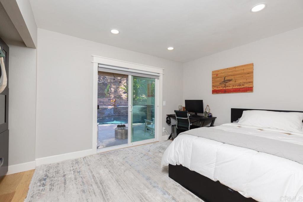 11061 Crystal Springs Road Santee, CA 92071 - Photo 15 of 30 a bedroom with a bed and a flat tv screen on the dresser