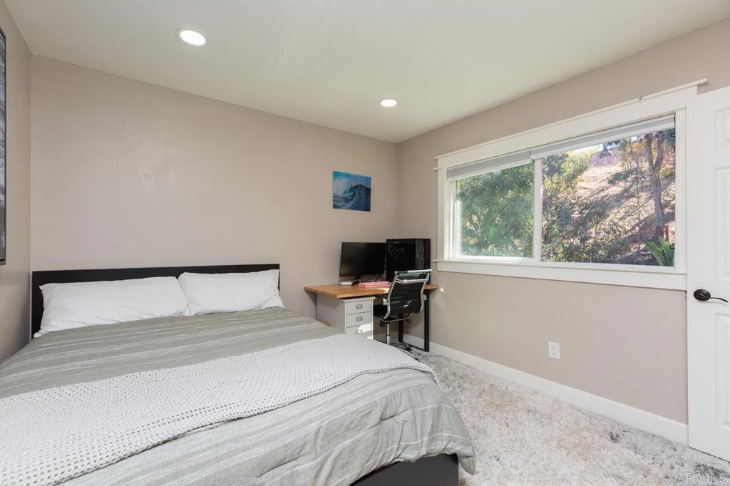 11061 Crystal Springs Road Santee, CA 92071 - Photo 19 of 30 a bedroom with a bed and a window