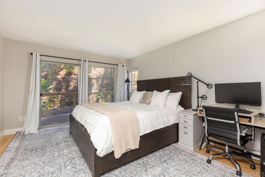 11061 Crystal Springs Road Santee, CA 92071 - Photo 21 of 30 a large bedroom with a bed and large window