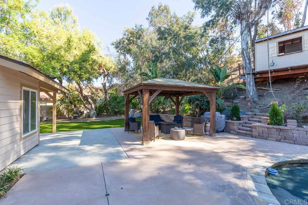 11061 Crystal Springs Road Santee, CA 92071 - Photo 28 of 30 a view of a patio with a table and chairs under an umbrella
