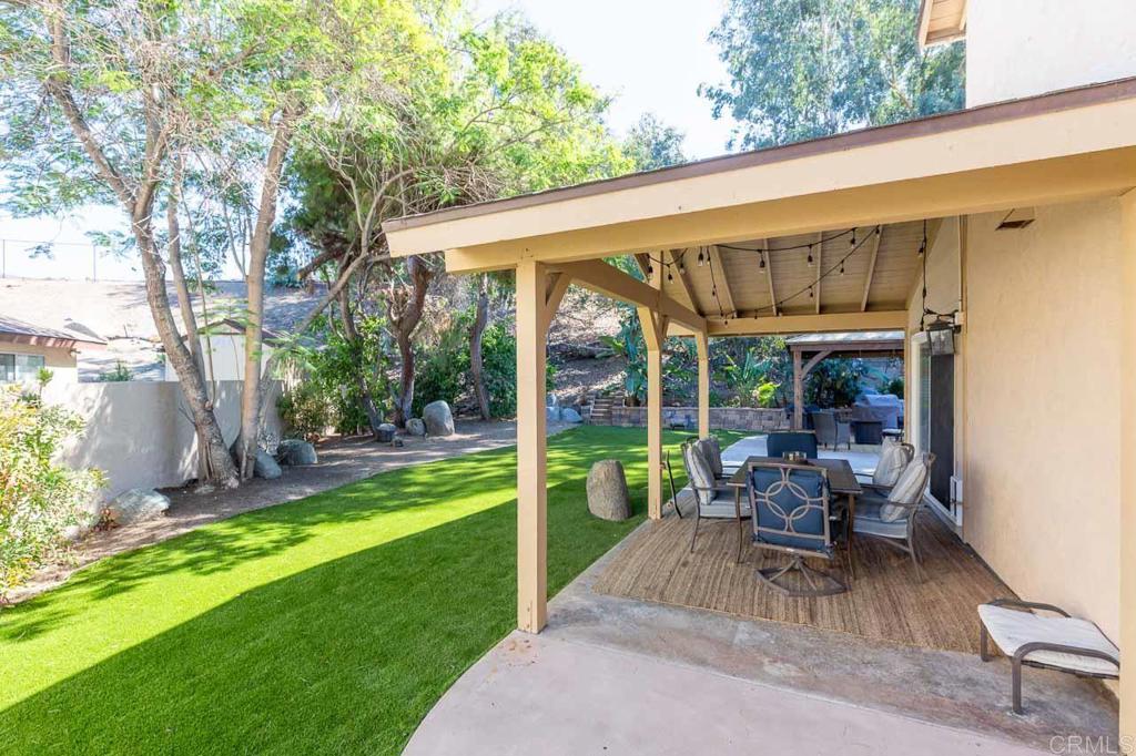 11061 Crystal Springs Road Santee, CA 92071 - Photo 29 of 30 a view of a patio with table and chairs next to a yard