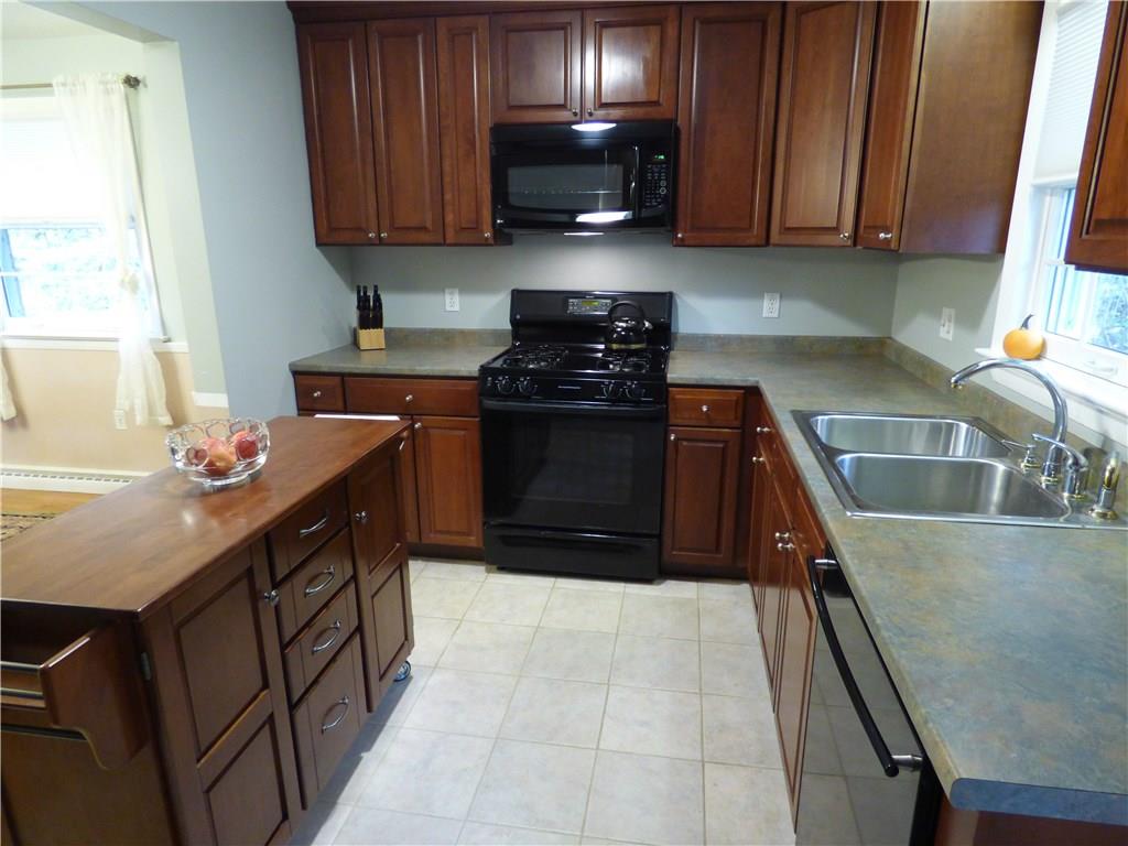 100 Bell Court Road McKees Rocks, PA 15136 - Photo 4 of 23 Portable island stays with the property. Notice the ceramic tile floor.