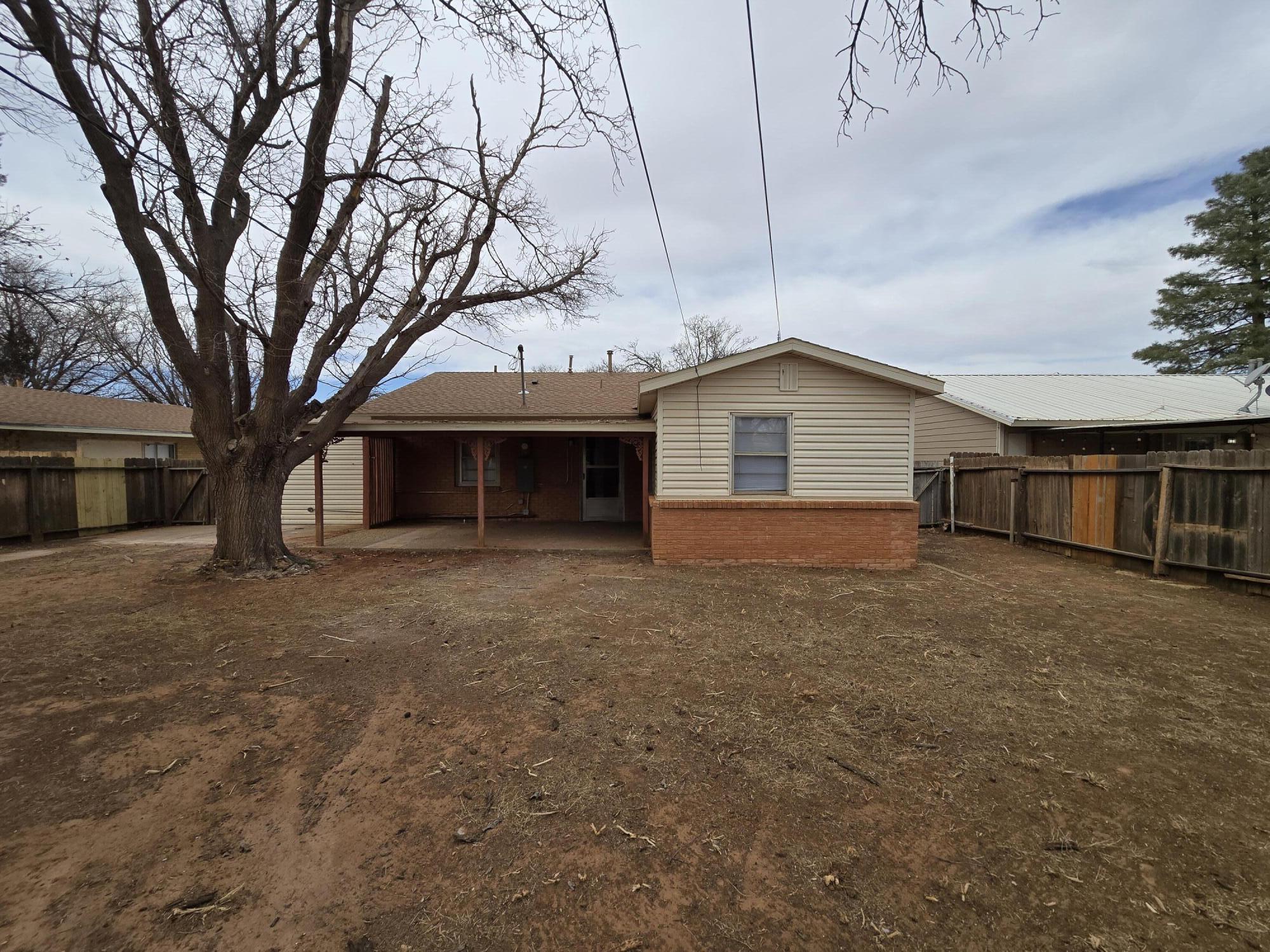 205 North 21st Street Lamesa, TX 79331 - Photo 12 of 14 a front view of house with yard and trees