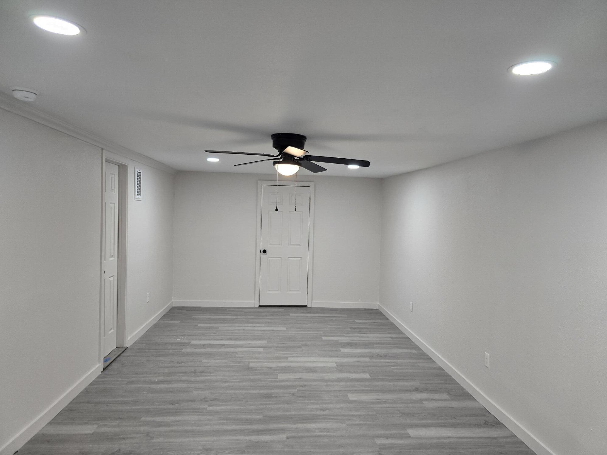 205 North 21st Street Lamesa, TX 79331 - Photo 5 of 14 wooden floor in an empty room with a window