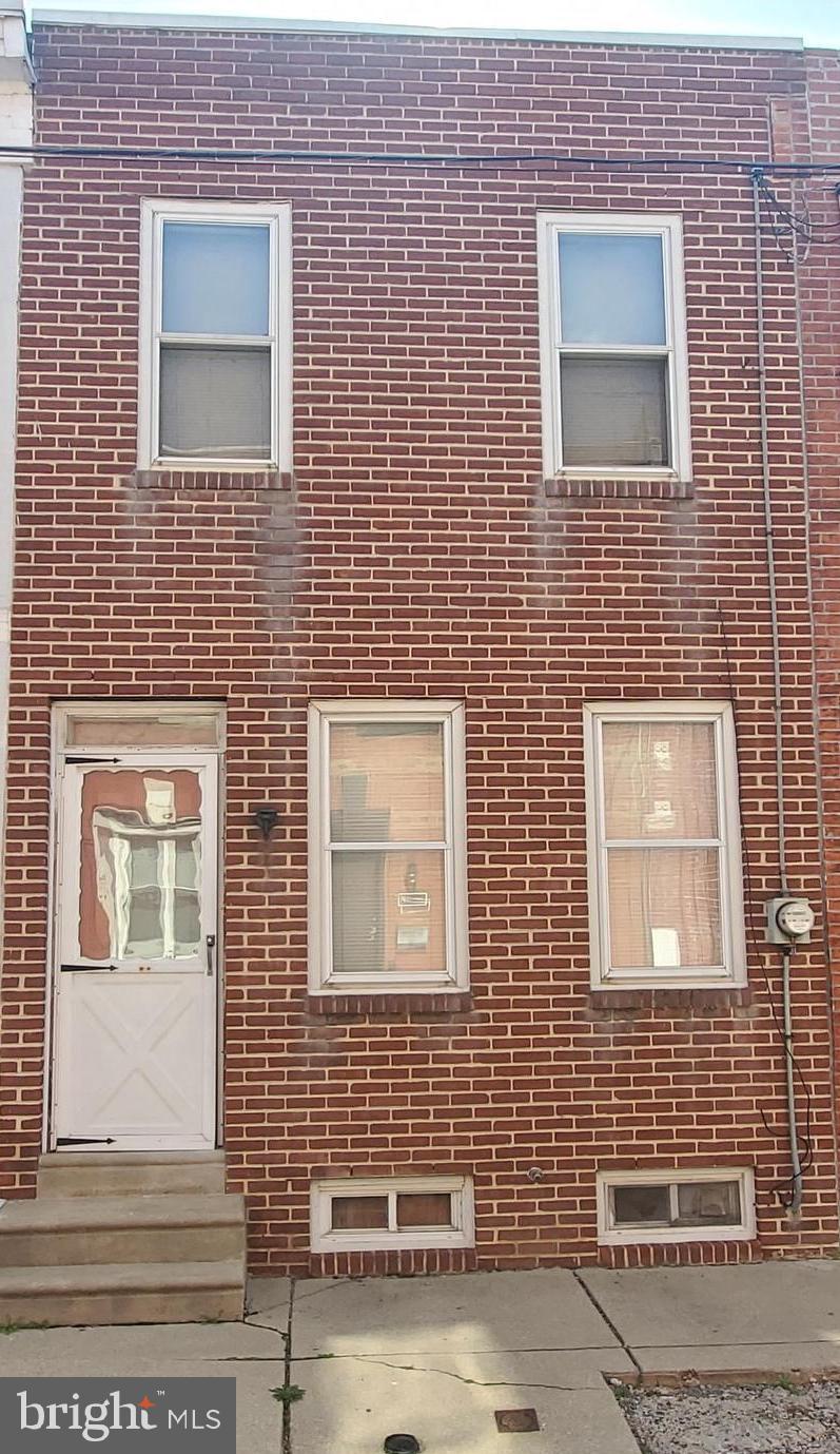 a brick house with four windows