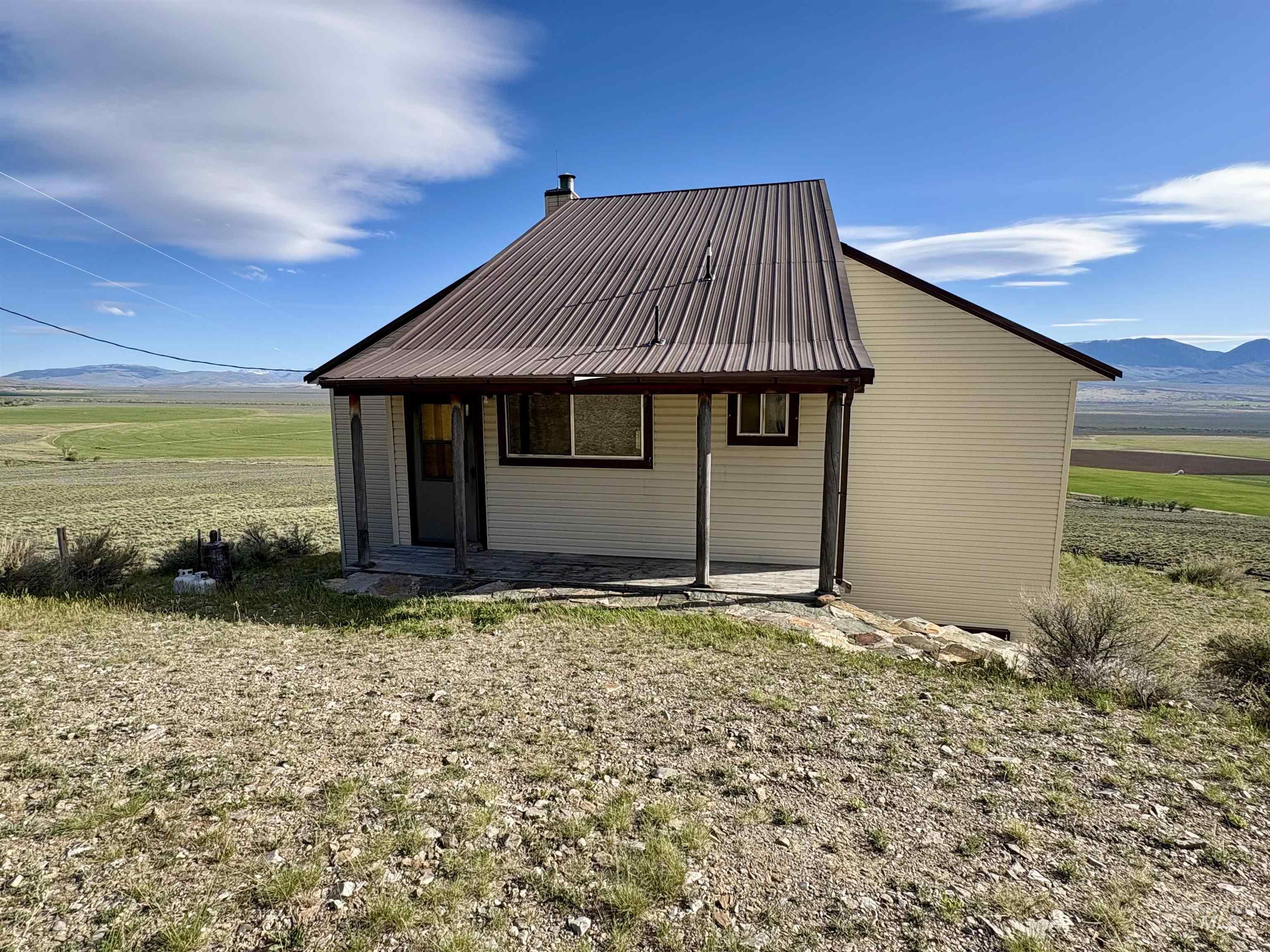 2040 Pahsimeroi River Road May, ID 83253 - Photo 9 of 29 Single-story structure featuring cream-colored siding and a brown metal roof