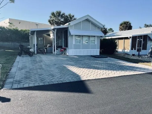 a view of a house with a yard and garage