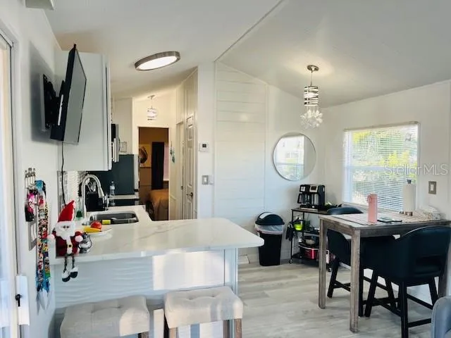 a living room with furniture a mirror and a flat screen tv