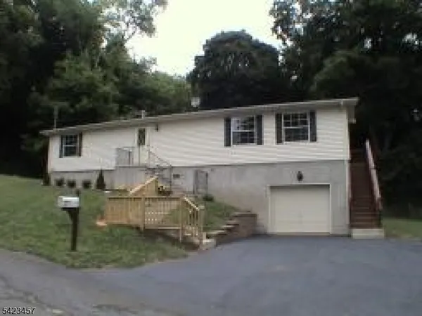 a view of a house with a yard and garage