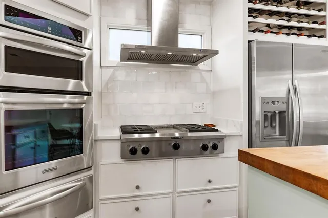 a stove top oven sitting inside of a kitchen