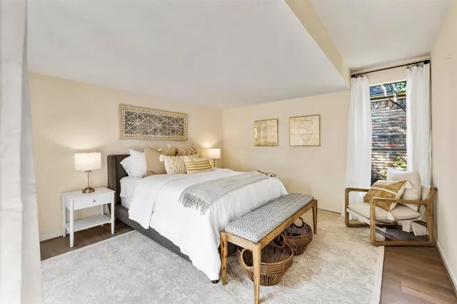 a spacious bedroom with a bed and a window