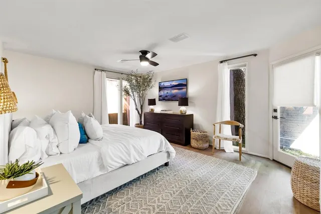 a bedroom with a large bed and a chandelier