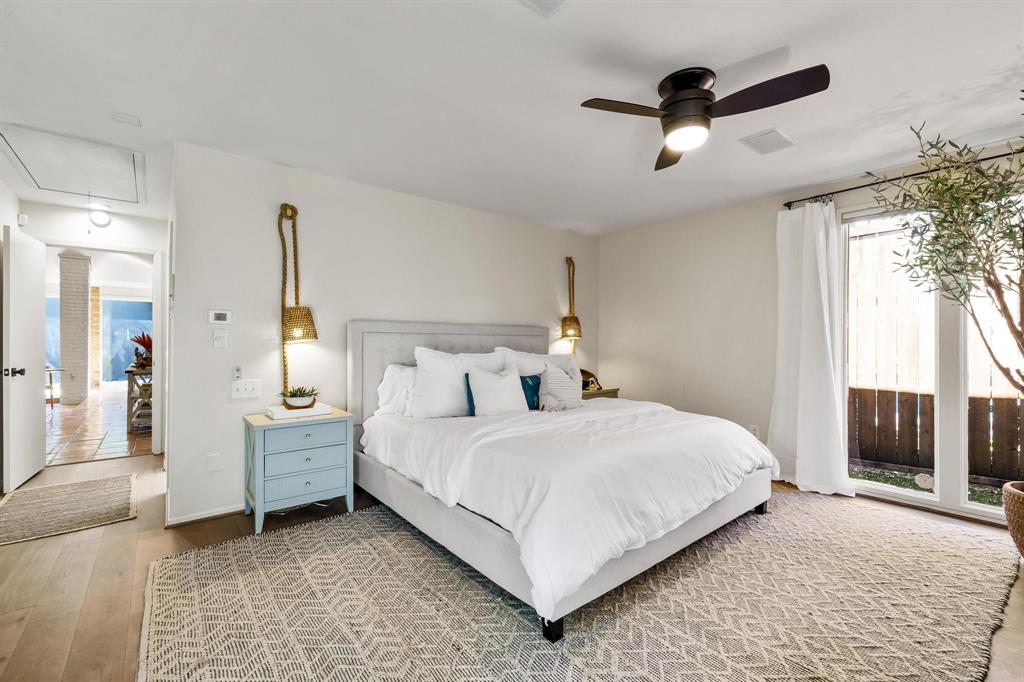 4338 Travis Street Dallas, TX 75205 - Photo 15 of 17 a bedroom with a bed and a chandelier