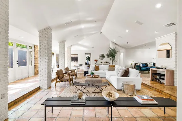 a living room with furniture a rug and a fireplace