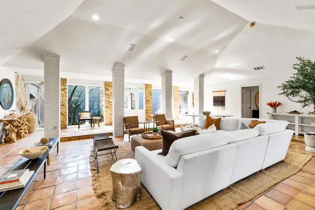 a large room with lots of white furniture