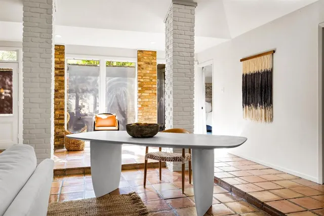 a view of a dining room with furniture and window