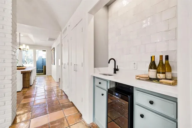 a hallway with sink and mirror