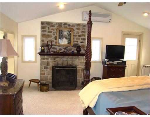 Master Bedroom. Vintage stone fireplace in master suite.