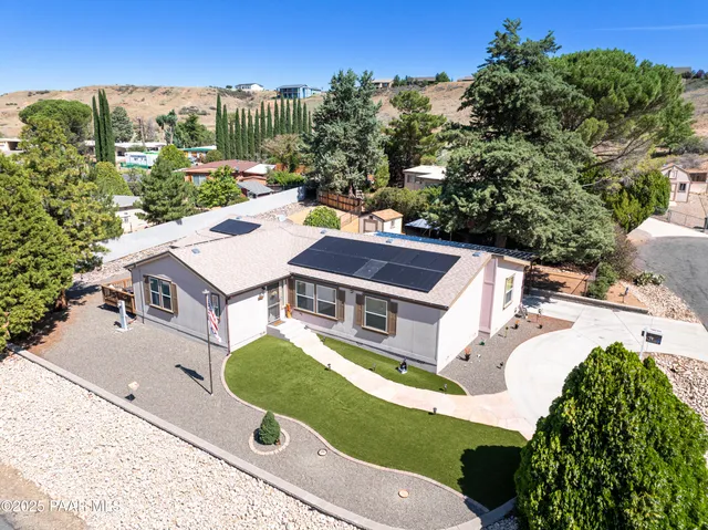 an aerial view of residential houses with yard