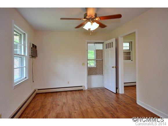 517 Tugaloo Road Landrum, SC 29356 - Photo 4 of 14 a view of an empty room with wooden floor and a window