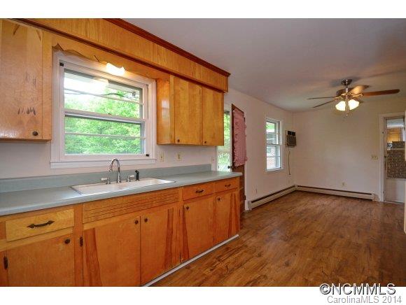 517 Tugaloo Road Landrum, SC 29356 - Photo 6 of 14 a kitchen with a sink a window and cabinets