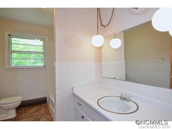 517 Tugaloo Road Landrum, SC 29356 - Photo 8 of 14 a bathroom with a granite countertop sink and a mirror