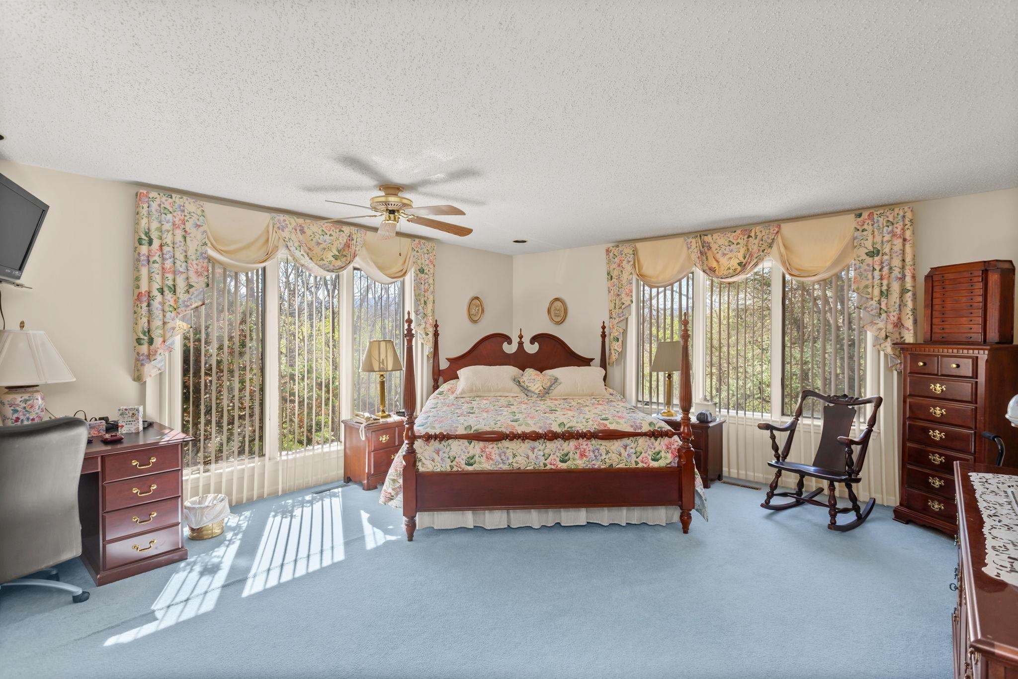13004 Indian Trail Road Broadway, VA 22815 - Photo 24 of 56 a spacious bedroom with a bed and a chandelier