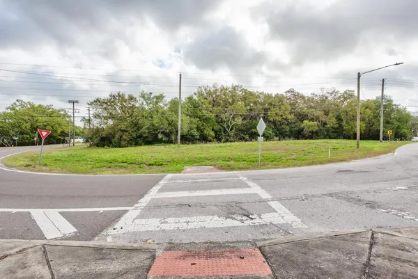 a view of a green field with wooden fence