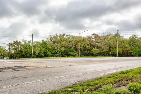 a view of a road with a building in the background