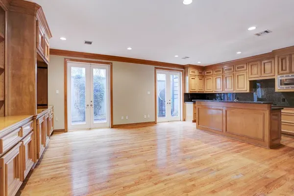 a large kitchen with stainless steel appliances granite countertop a refrigerator and a stove top oven