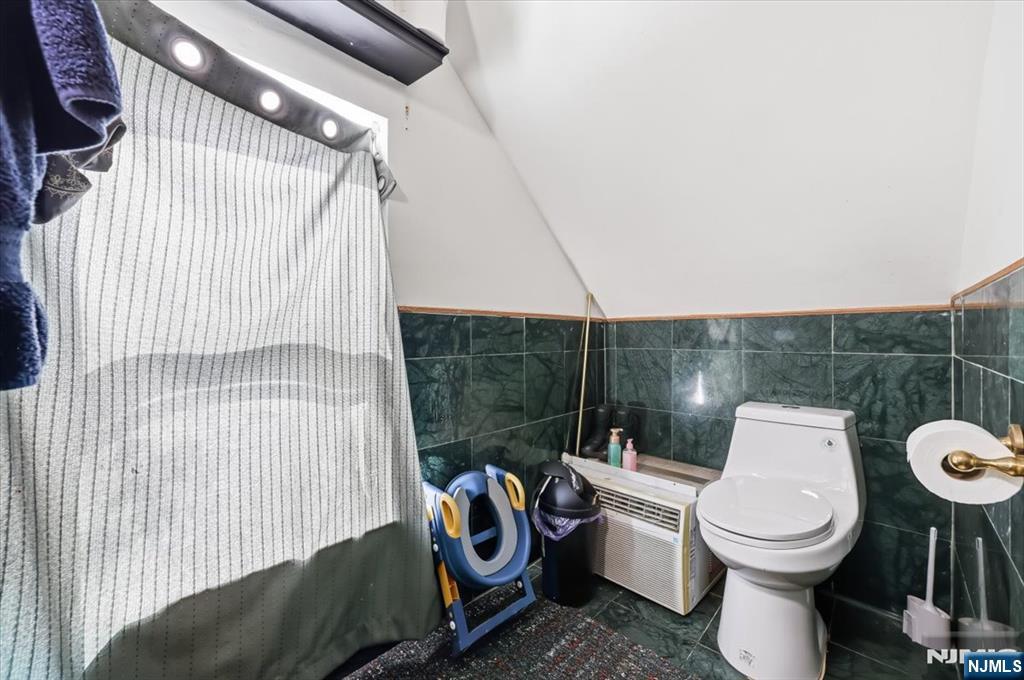 409 Tryon Avenue Englewood, NJ 07631 - Photo 23 of 33 a bathroom with a toilet and a shower