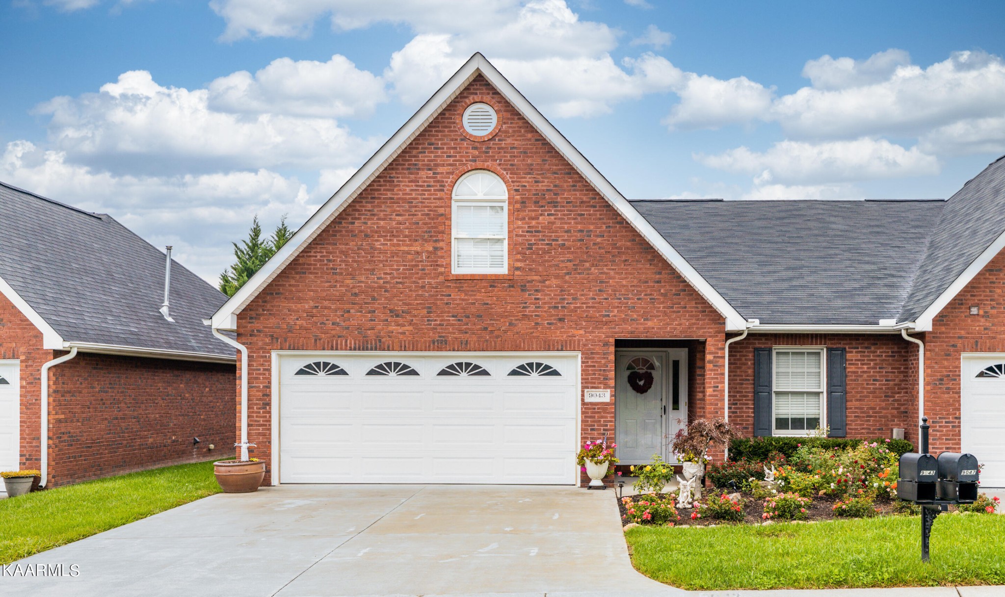 9043 Rocky Ridge Way, Unit 9 Knoxville, TN 37924 - Photo 1 of 31 a front view of a house with garden