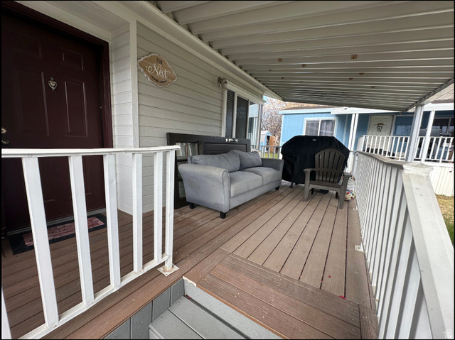 265 Mindella Way Layton, UT 84041 - Photo 4 of 32 Covered porch featuring wood-finish decking and white railings