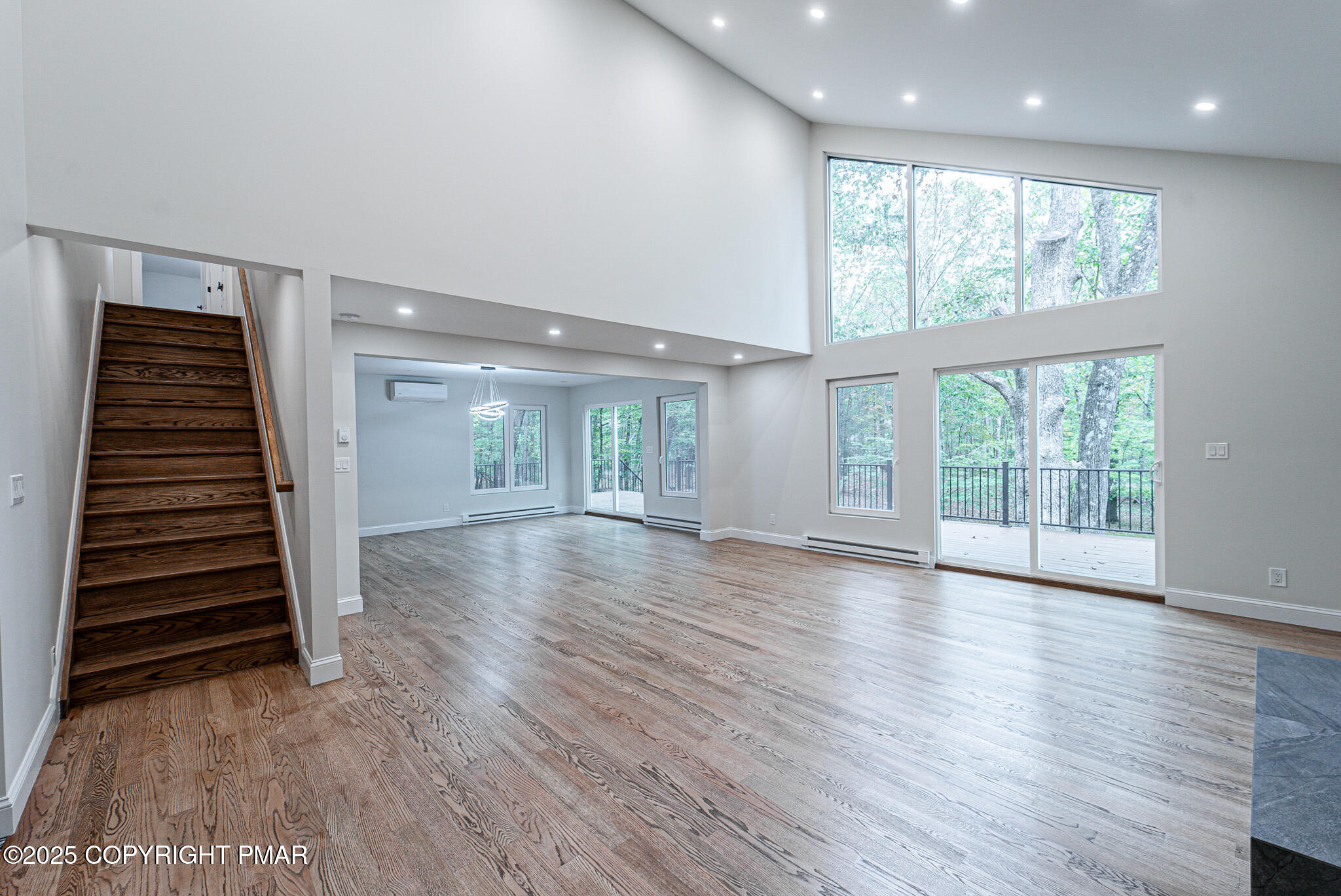 5806 Decker Road Bushkill, PA 18324 - Photo 15 of 76 an empty room with wooden floor and windows