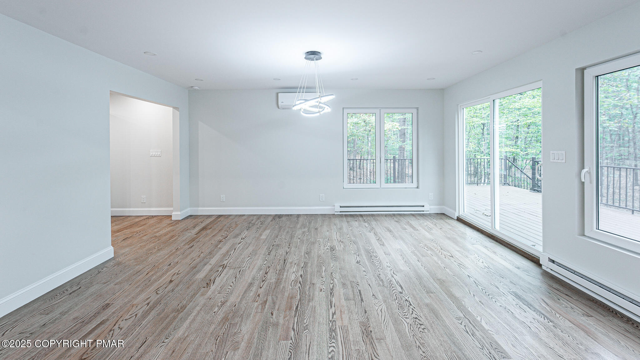 5806 Decker Road Bushkill, PA 18324 - Photo 20 of 76 an empty room with wooden floor and windows