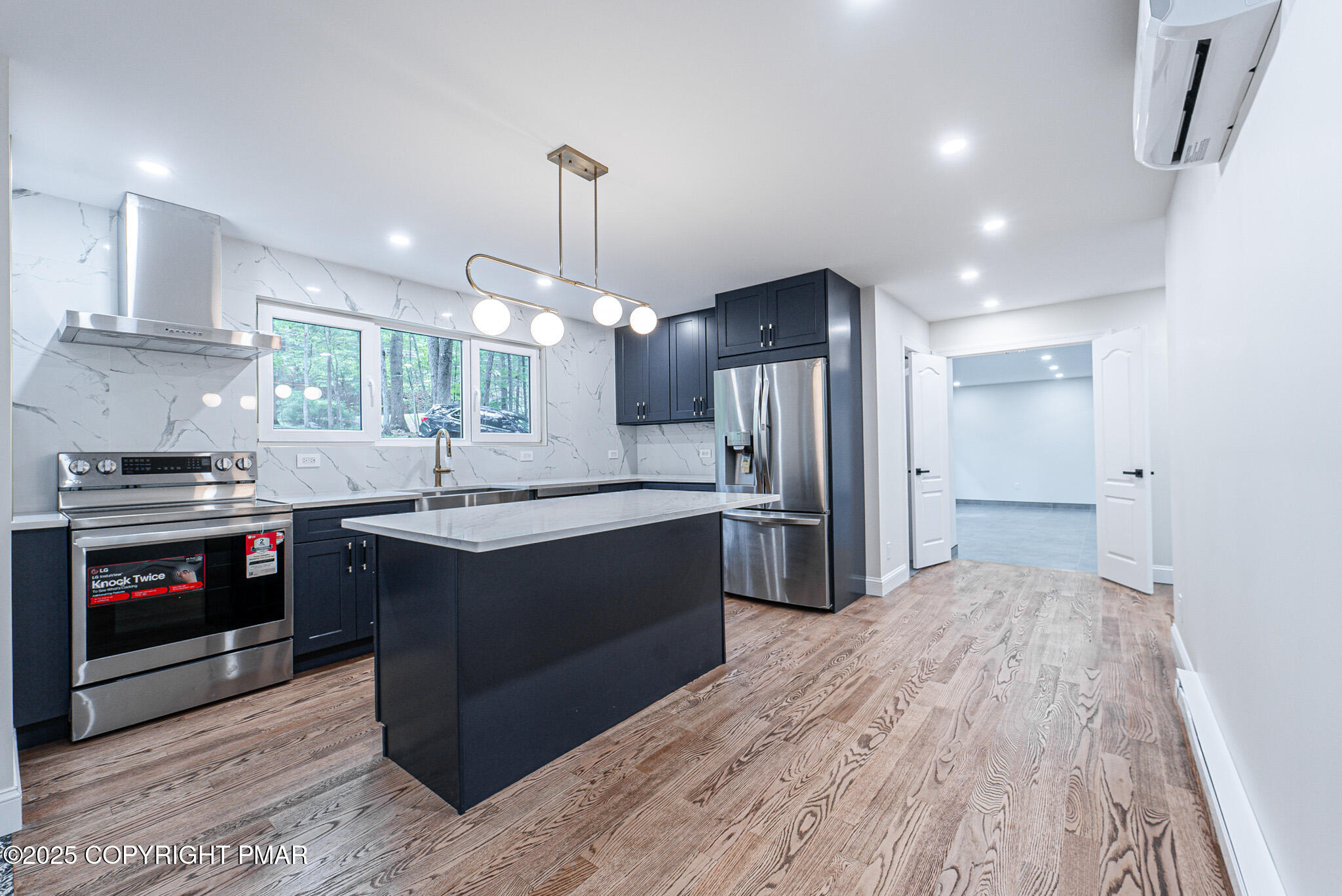 5806 Decker Road Bushkill, PA 18324 - Photo 22 of 76 a kitchen with kitchen island a sink stainless steel appliances and cabinets