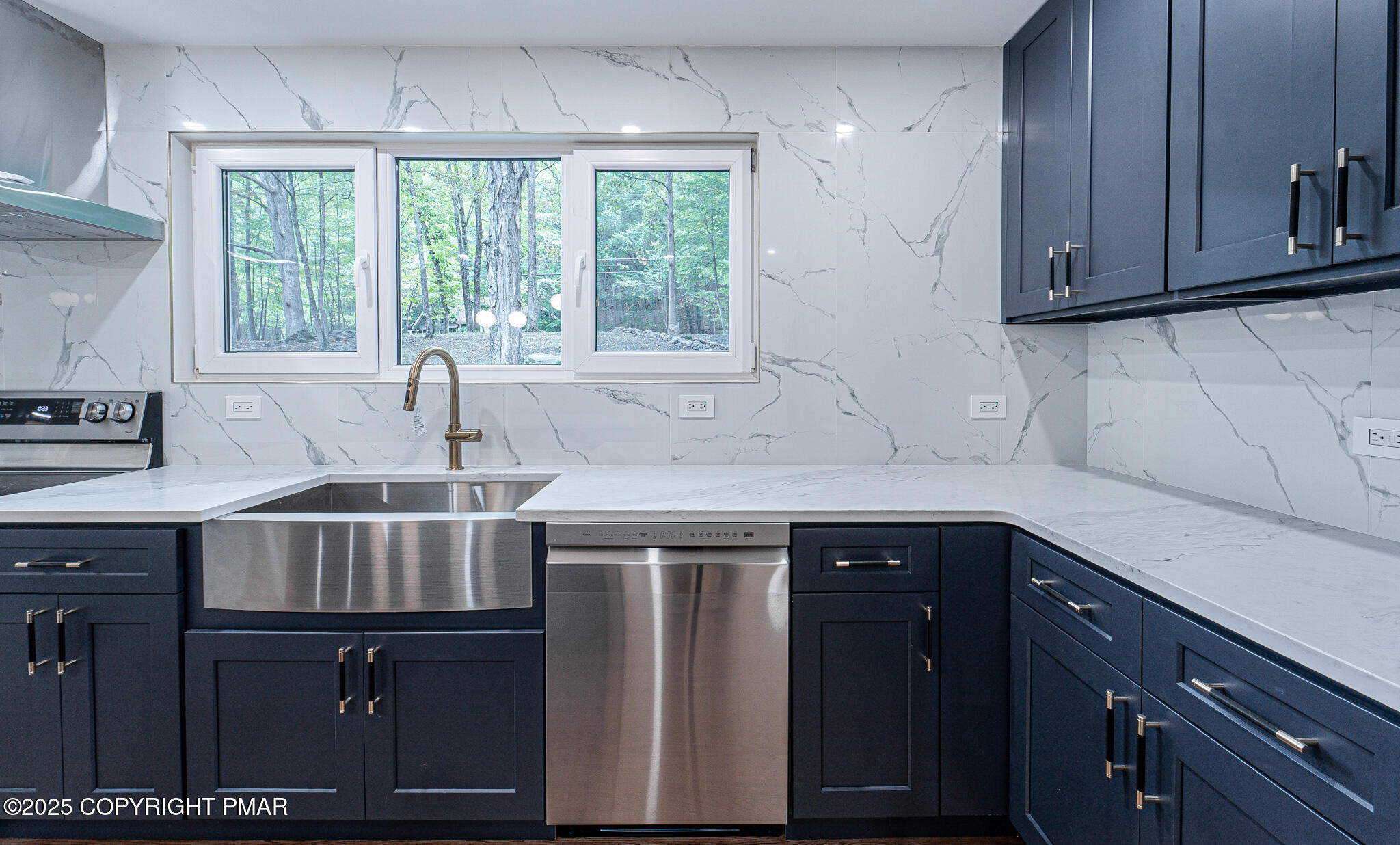 5806 Decker Road Bushkill, PA 18324 - Photo 23 of 76 a kitchen with stainless steel appliances granite countertop a sink and a stove