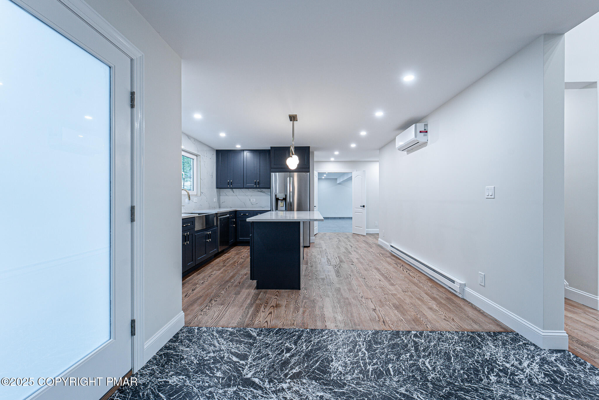 5806 Decker Road Bushkill, PA 18324 - Photo 28 of 76 a view of kitchen with kitchen island a sink wooden floor and a counter top space