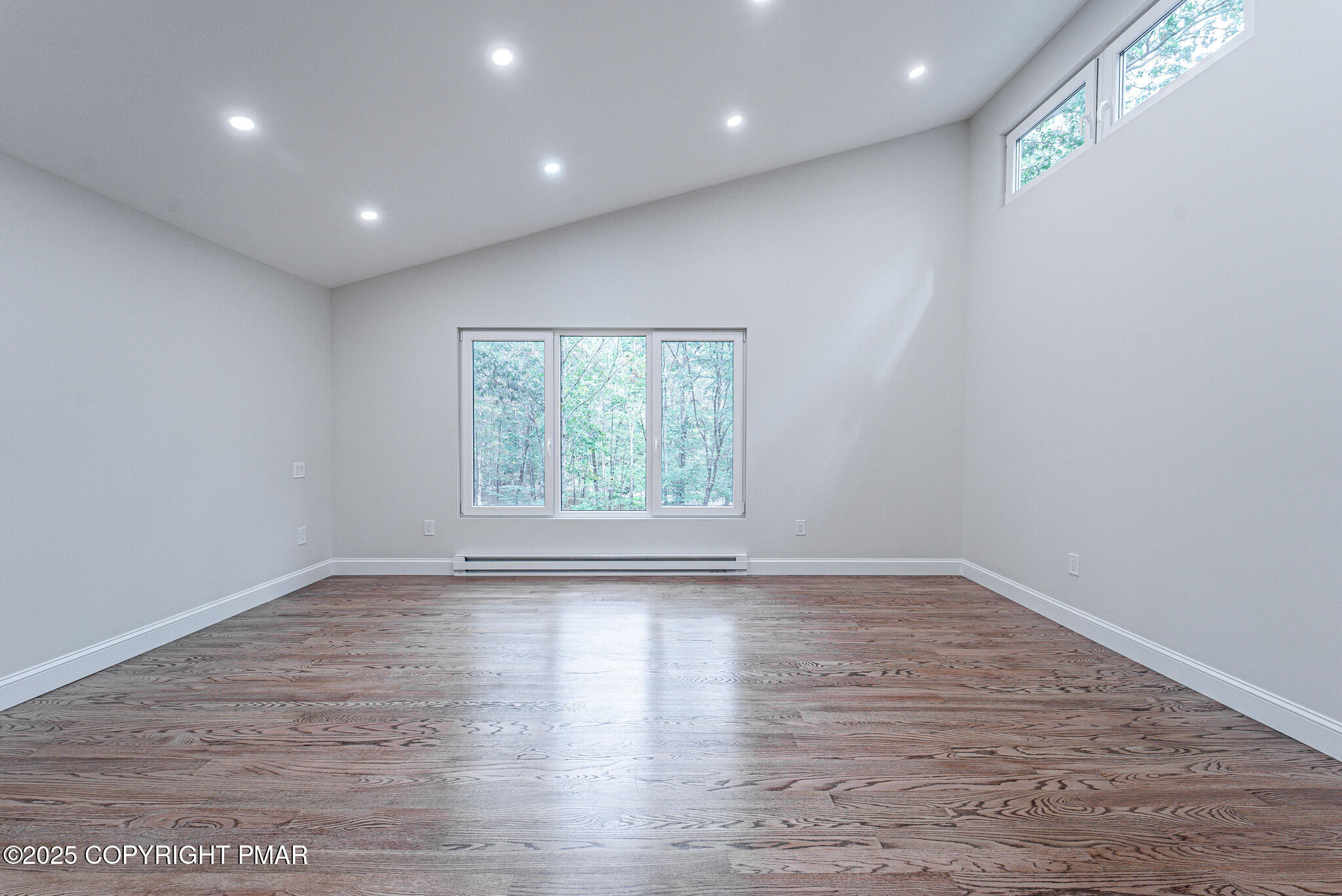5806 Decker Road Bushkill, PA 18324 - Photo 39 of 76 an empty room with wooden floor and windows