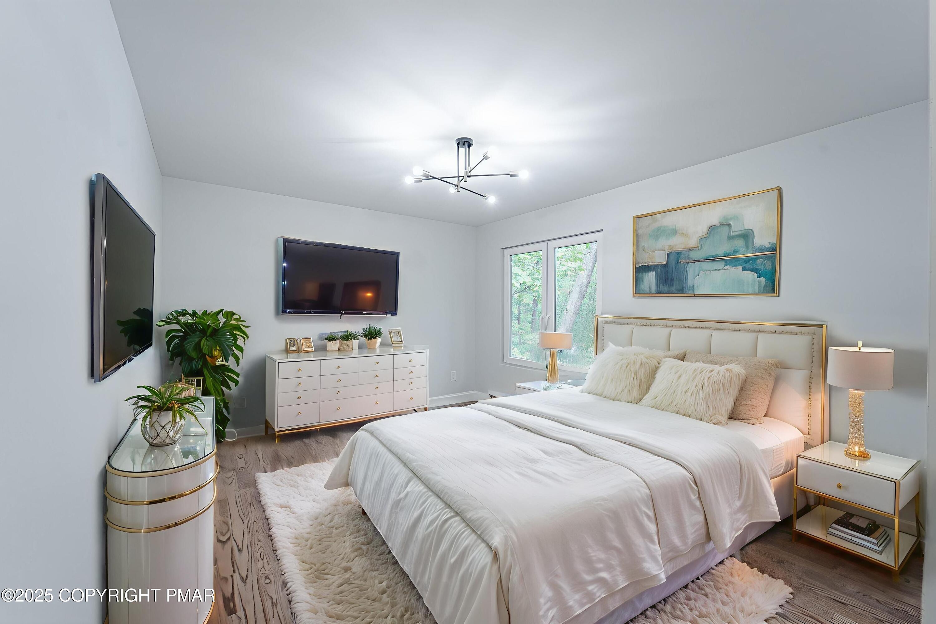 5806 Decker Road Bushkill, PA 18324 - Photo 45 of 76 a bedroom with a bed and a flat screen tv